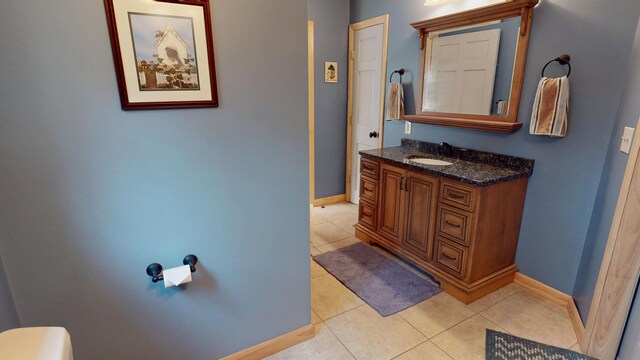 129 Maple Shore Ln, Stetson, ME 04488 - bathroom featuring vanity, tile patterned flooring, baseboards, and toilet