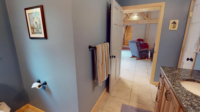 129 Maple Shore Ln, Stetson, ME 04488 - bathroom with tile patterned flooring, vanity, baseboards, and lofted ceiling
