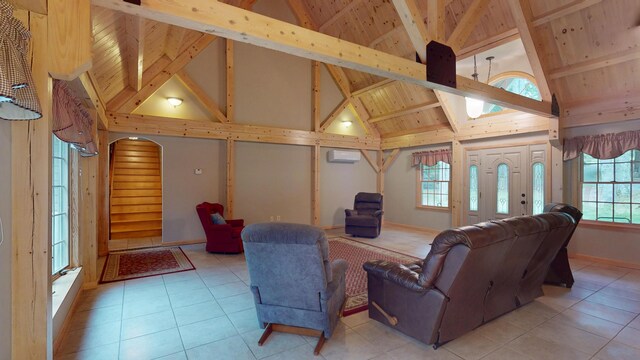129 Maple Shore Ln, Stetson, ME 04488 - living room with a wall mounted AC, high vaulted ceiling, light tile patterned floors, wood ceiling with exposed beams, and baseboards