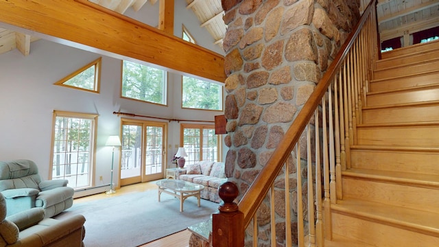 129 Maple Shore Ln, Stetson, ME 04488 - living area with high vaulted ceiling, a baseboard radiator, stairs, beam ceiling, and wood finished floors