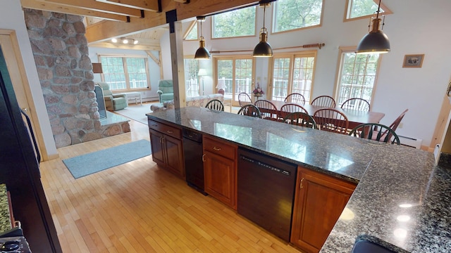 129 Maple Shore Ln, Stetson, ME 04488 - kitchen with black dishwasher, light wood-style flooring, brown cabinets, hanging light fixtures, and a towering ceiling