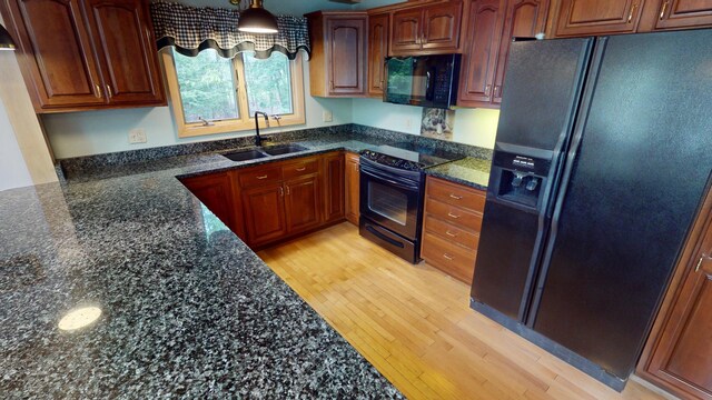 129 Maple Shore Ln, Stetson, ME 04488 - kitchen featuring black appliances, a sink, light wood finished floors, and dark stone countertops