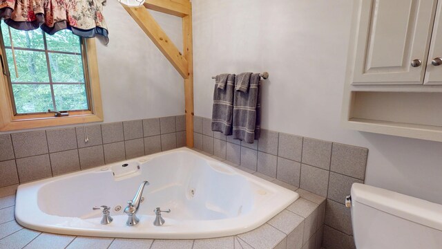 129 Maple Shore Ln, Stetson, ME 04488 - bathroom with a tub with jets and toilet