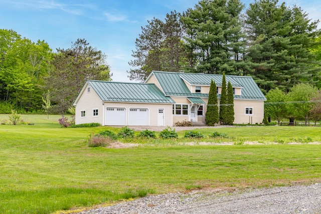 303 Williams Rd, Bradford, ME 04410 - view of front of house with a standing seam roof, an attached garage, and a front lawn