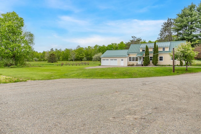 303 Williams Rd, Bradford, ME 04410 - view of front of property featuring driveway, a front yard, an attached garage, and a standing seam roof