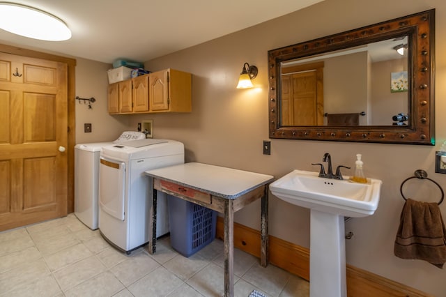 303 Williams Rd, Bradford, ME 04410 - laundry room with washer and dryer, cabinet space, and light tile patterned floors