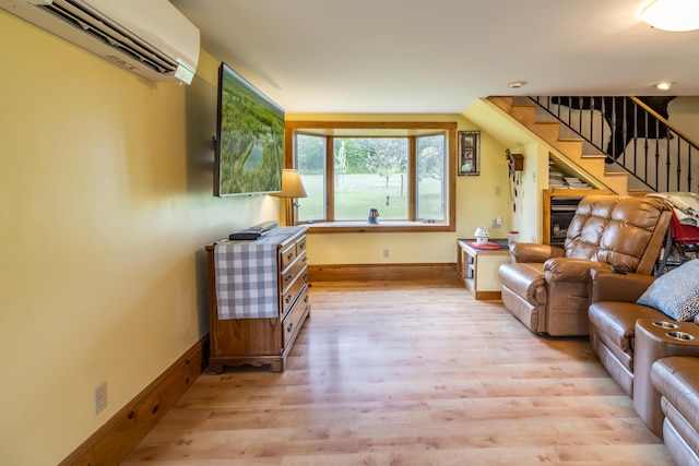 303 Williams Rd, Bradford, ME 04410 - living area featuring a wall unit AC, light wood-style floors, and stairway