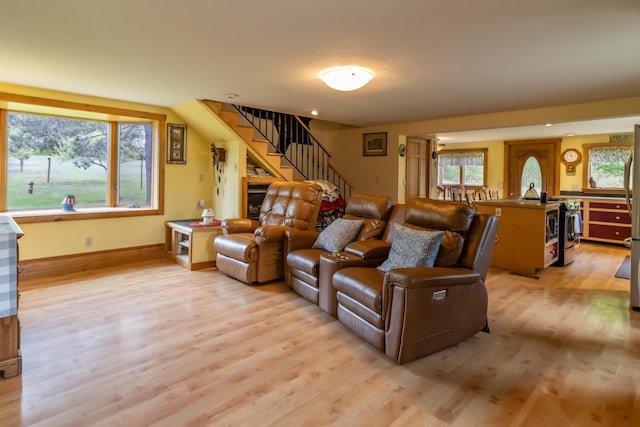 303 Williams Rd, Bradford, ME 04410 - living room featuring light wood-type flooring, stairway, and healthy amount of natural light