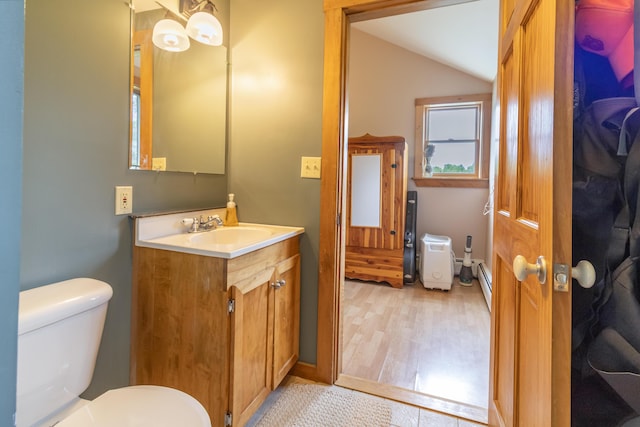 303 Williams Rd, Bradford, ME 04410 - bathroom with vaulted ceiling, vanity, and wood finished floors