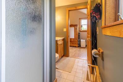 303 Williams Rd, Bradford, ME 04410 - full bathroom featuring a shower with shower door, vanity, and tile patterned flooring