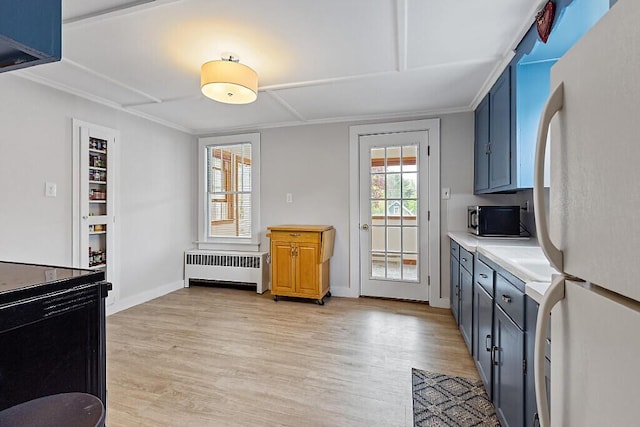 20 Donald St, Waterville, ME 04901 - kitchen with freestanding refrigerator, radiator, light wood-style floors, light countertops, and baseboards