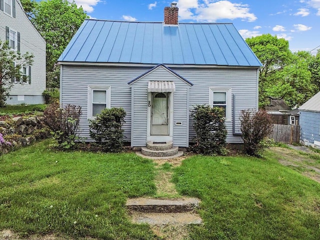 20 Donald St, Waterville, ME 04901 - view of front facade featuring a standing seam roof, a chimney, and metal roof