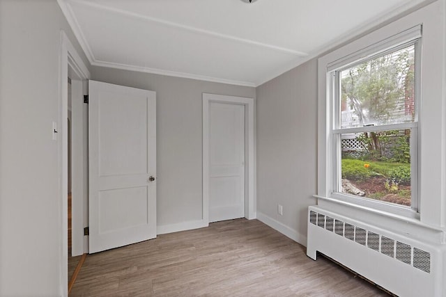 20 Donald St, Waterville, ME 04901 - unfurnished bedroom featuring radiator, light wood-type flooring, ornamental molding, and baseboards