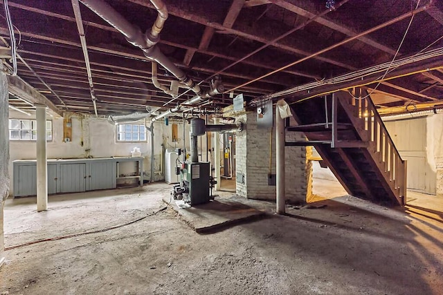20 Donald St, Waterville, ME 04901 - basement featuring water heater, a heating unit, and stairs