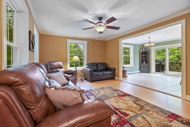 15 Convene Rd, Sebago, ME 04029 - living room featuring a baseboard radiator, wood finished floors, baseboards, a chandelier, and ornamental molding