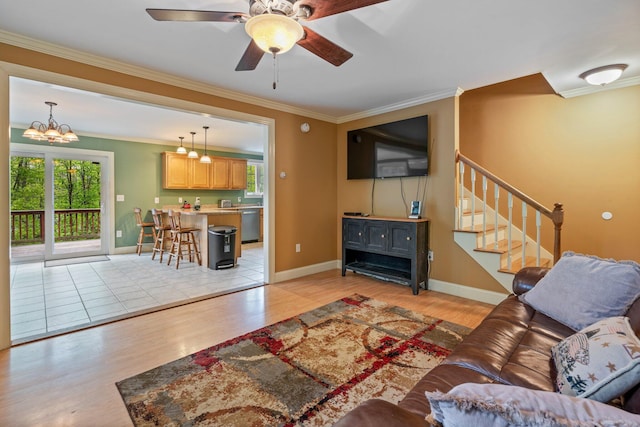 15 Convene Rd, Sebago, ME 04029 - living area featuring ornamental molding, light wood-style floors, healthy amount of natural light, and stairs