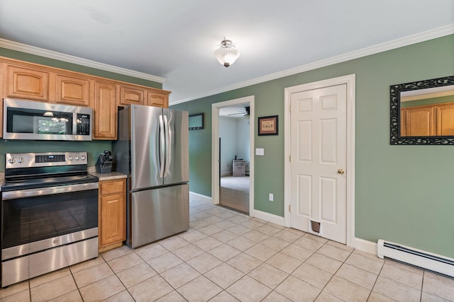 15 Convene Rd, Sebago, ME 04029 - kitchen with appliances with stainless steel finishes, baseboard heating, light tile patterned flooring, ornamental molding, and baseboards