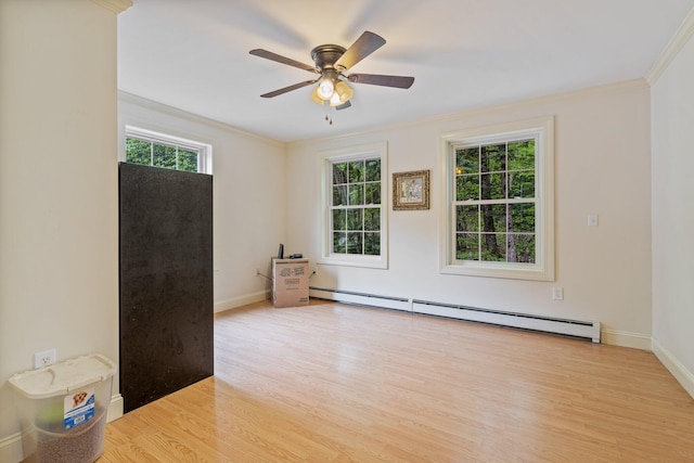 15 Convene Rd, Sebago, ME 04029 - unfurnished room featuring baseboard heating, ornamental molding, ceiling fan, light wood finished floors, and baseboards