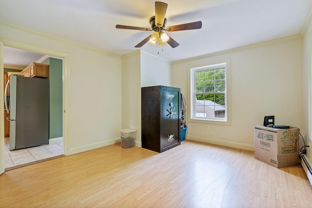 15 Convene Rd, Sebago, ME 04029 - unfurnished bedroom with freestanding refrigerator, light wood finished floors, crown molding, baseboards, and a ceiling fan