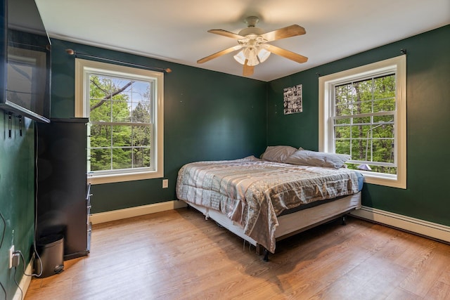 15 Convene Rd, Sebago, ME 04029 - bedroom with multiple windows, wood finished floors, and baseboards