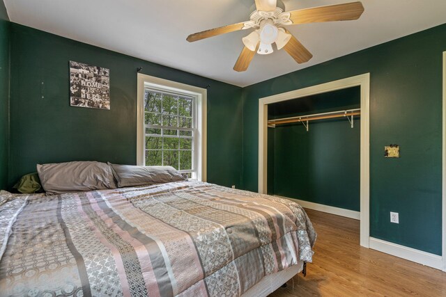 15 Convene Rd, Sebago, ME 04029 - bedroom with baseboards, wood finished floors, a ceiling fan, and a closet