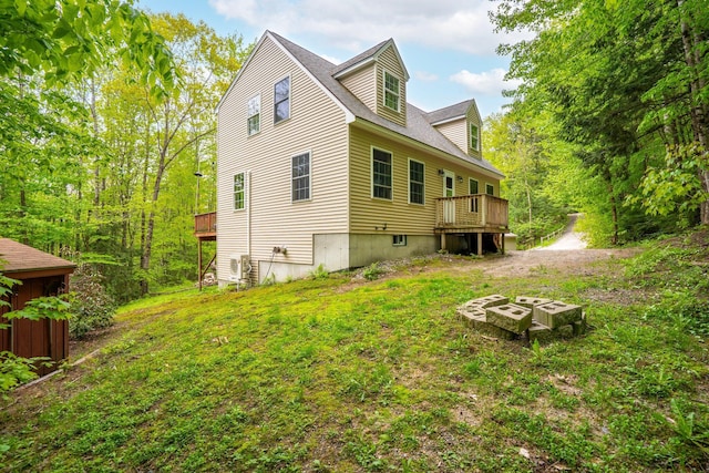 15 Convene Rd, Sebago, ME 04029 - back of property with a deck and an outdoor fire pit