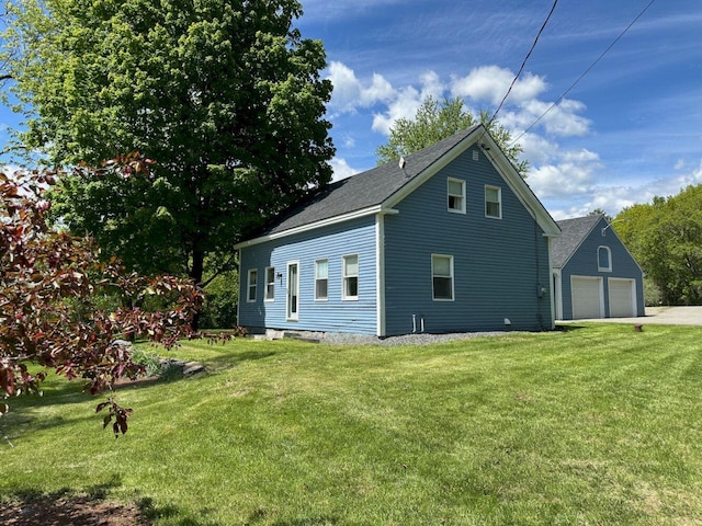10 Research Dr, Skowhegan, ME 04976 - view of side of home featuring a yard, roof with shingles, and asphalt driveway