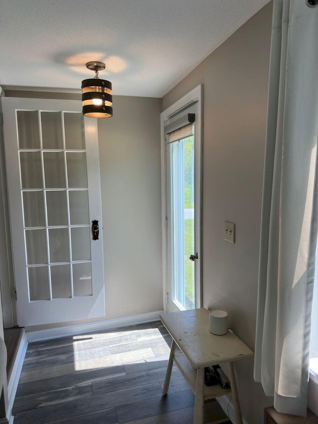 10 Research Dr, Skowhegan, ME 04976 - doorway with wood finished floors, baseboards, and a textured ceiling