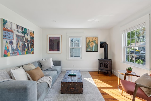 90 Wellington Rd, Portland, ME 04103 - living room featuring wood finished floors, baseboards, a wood stove, and recessed lighting