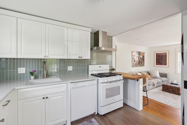 90 Wellington Rd, Portland, ME 04103 - kitchen with white appliances, wall chimney range hood, a sink, dark wood finished floors, and light countertops