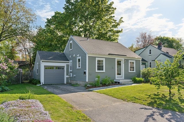 90 Wellington Rd, Portland, ME 04103 - view of front of home with roof with shingles, asphalt driveway, and a garage