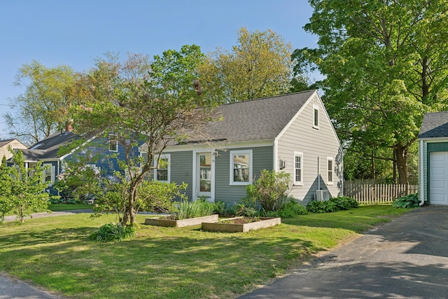 90 Wellington Rd, Portland, ME 04103 - cape cod home featuring a garage, driveway, and roof with shingles