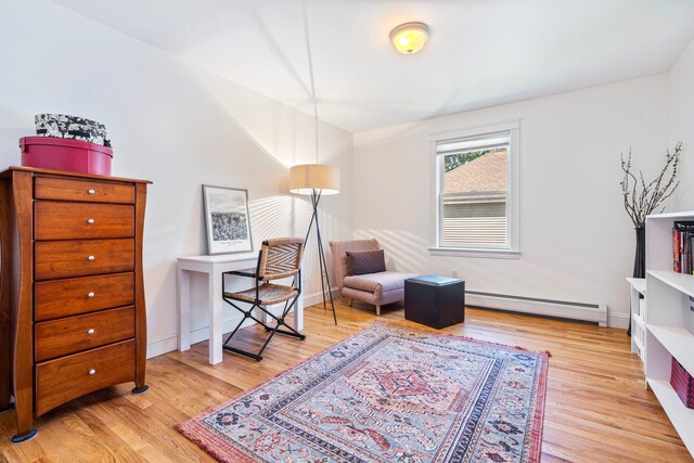 44 Yale St, Portland, ME 04103 - living area with baseboard heating, light wood finished floors, and baseboards