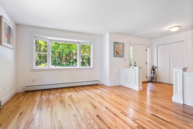 44 Yale St, Portland, ME 04103 - unfurnished living room with a baseboard radiator, light wood-style flooring, and baseboards