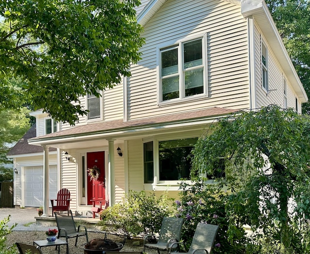 44 Yale St, Portland, ME 04103 - view of front of property featuring covered porch, an attached garage, and driveway