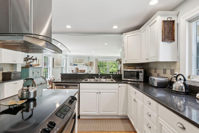 401 Princes Point Rd, Yarmouth, ME 04096 - kitchen featuring stainless steel appliances, island range hood, white cabinetry, a sink, and a peninsula