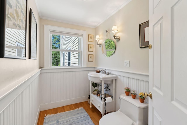 401 Princes Point Rd, Yarmouth, ME 04096 - half bathroom with wainscoting, toilet, wood finished floors, crown molding, and a sink