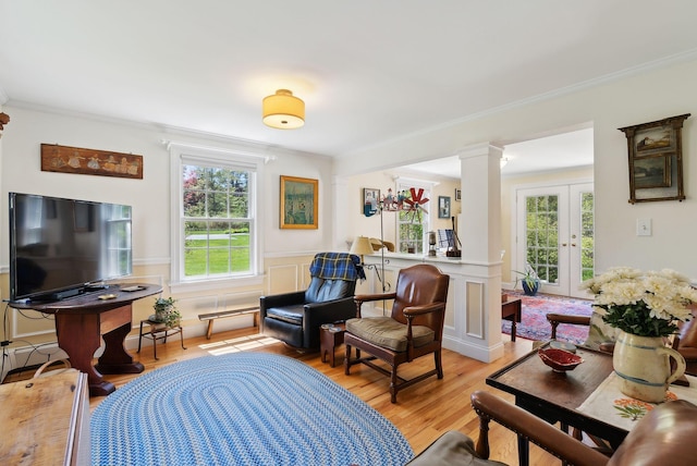 401 Princes Point Rd, Yarmouth, ME 04096 - living area with healthy amount of natural light, light wood-style floors, ornate columns, crown molding, and a wainscoted wall