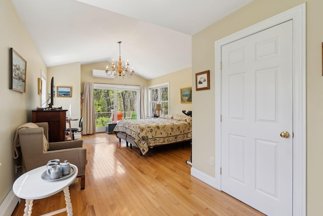 401 Princes Point Rd, Yarmouth, ME 04096 - bedroom with light wood-style flooring, a chandelier, an AC wall unit, and vaulted ceiling