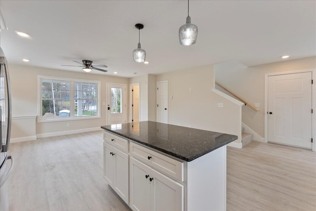12 Casey Ln, Old Orchard Beach, ME 04064 - kitchen with light wood-style floors, a ceiling fan, pendant lighting, open floor plan, and white cabinets