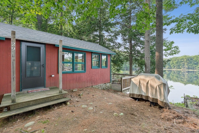 29 Island Pond Rd, Leeds, ME 04263 - view of side of home with roof with shingles and a wooden deck