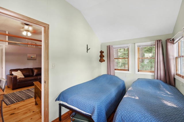 29 Island Pond Rd, Leeds, ME 04263 - bedroom featuring vaulted ceiling, wood finished floors, and multiple windows