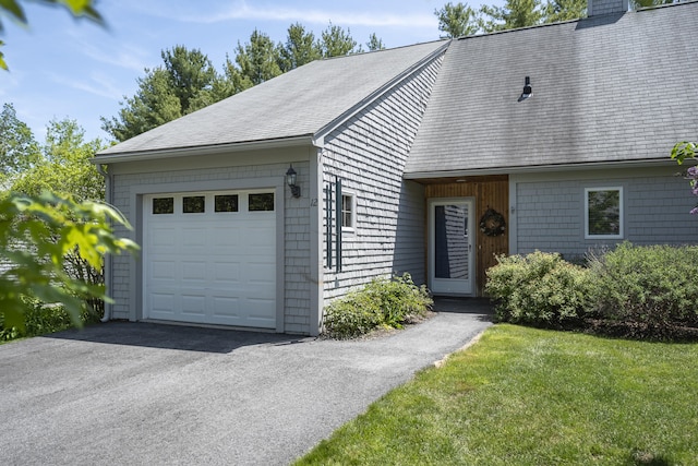 65 Pine Point Rd Unit 12, Scarborough, ME 04074 - view of front of house featuring an attached garage, asphalt driveway, a chimney, and a shingled roof