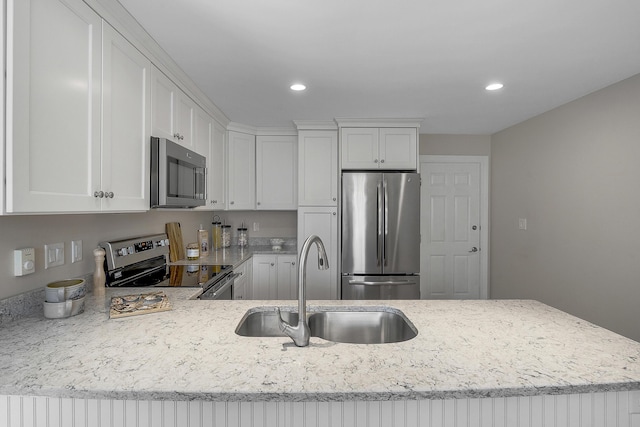 65 Pine Point Rd Unit 12, Scarborough, ME 04074 - kitchen with appliances with stainless steel finishes, a sink, light stone countertops, white cabinets, and recessed lighting