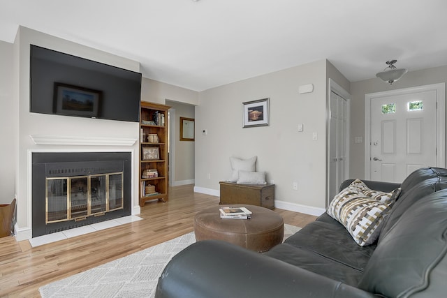 65 Pine Point Rd Unit 12, Scarborough, ME 04074 - living room with wood finished floors, a fireplace with flush hearth, and baseboards