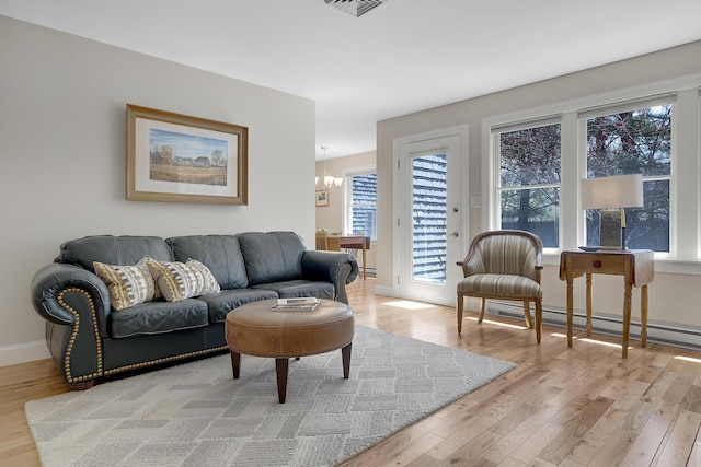 65 Pine Point Rd Unit 12, Scarborough, ME 04074 - living room featuring light wood finished floors, a chandelier, and healthy amount of natural light