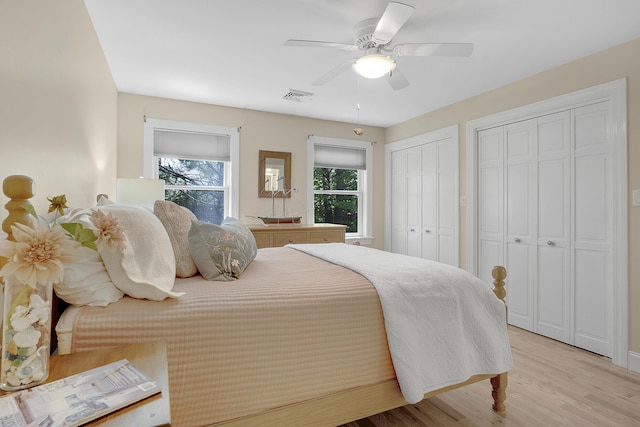 65 Pine Point Rd Unit 12, Scarborough, ME 04074 - bedroom with multiple closets, light wood-type flooring, and ceiling fan