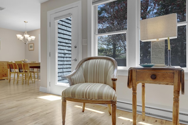 65 Pine Point Rd Unit 12, Scarborough, ME 04074 - living area featuring a chandelier, wood finished floors, and plenty of natural light
