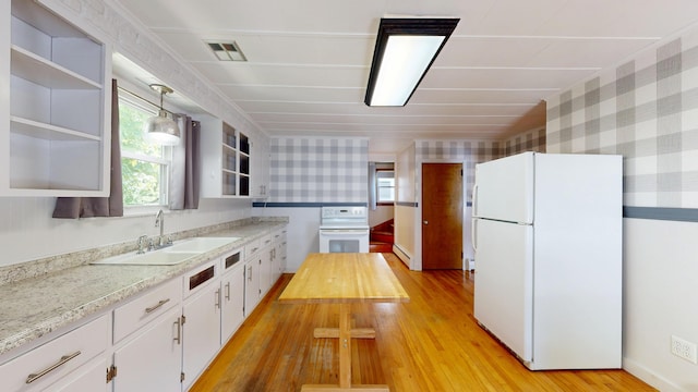 118 Riverside Dr, Auburn, ME 04210 - kitchen featuring white appliances, a sink, wallpapered walls, light wood finished floors, and light countertops