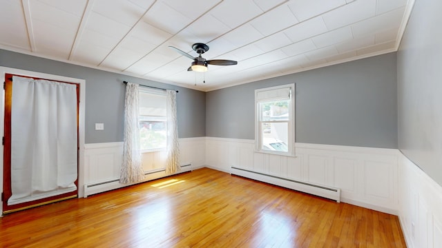 118 Riverside Dr, Auburn, ME 04210 - unfurnished room with a baseboard radiator, ceiling fan, wainscoting, light wood-type flooring, and ornamental molding